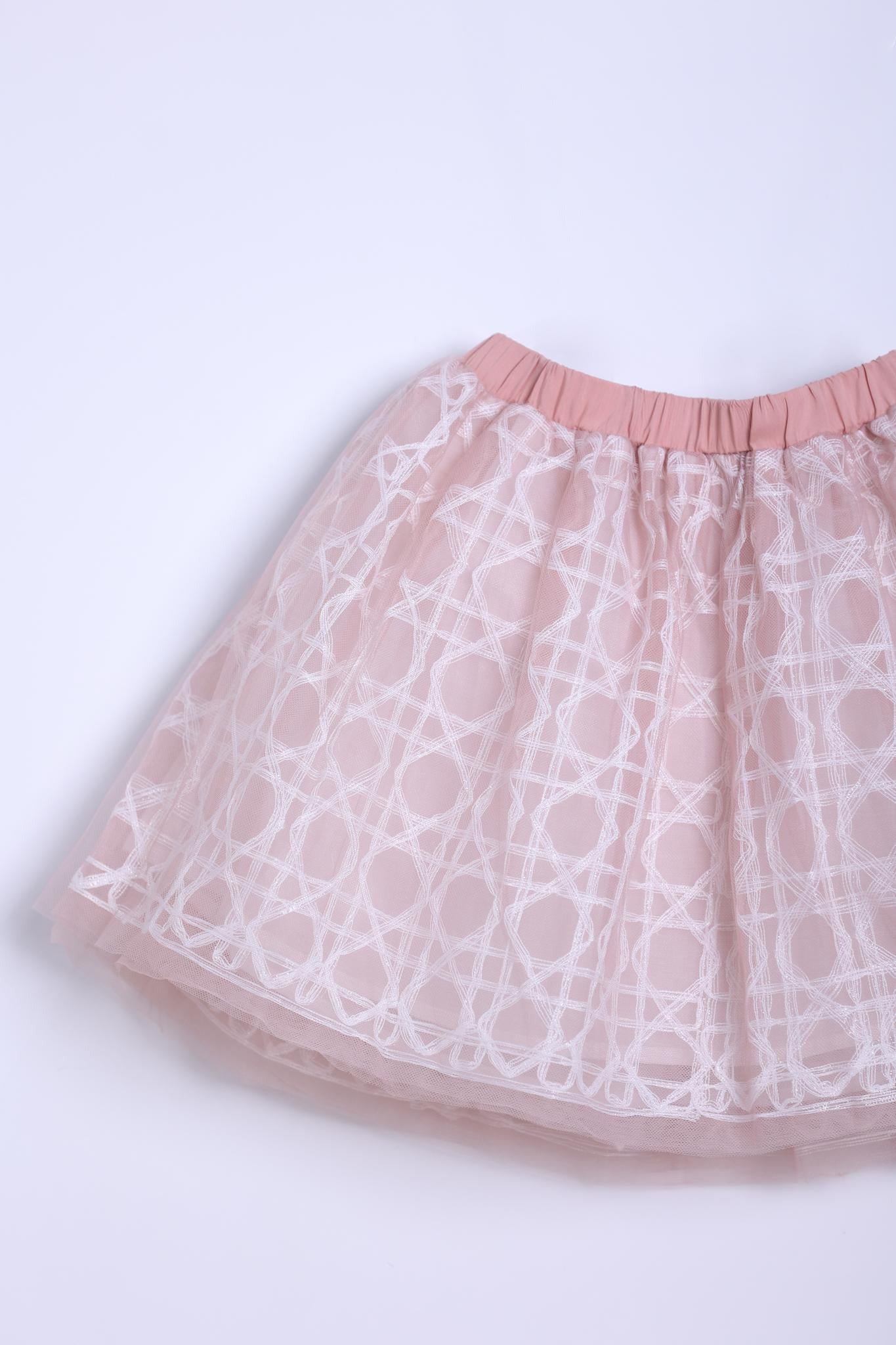 The KIKI and JOJO Girls Tulle Skirt – Darling Blush Pink features a lace-embroidered overlay with white geometric patterns and a solid elastic waistband, shown against a plain light background.