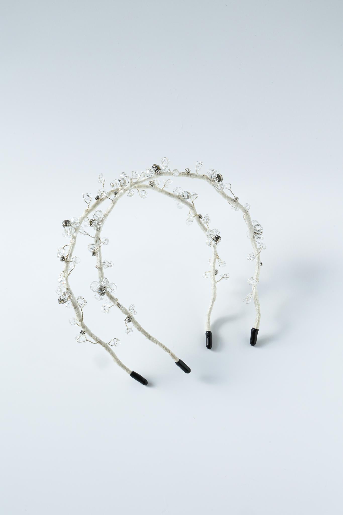 Two Beaded Flower Girl Headbands by KIKI and JOJO feature gold wire-wrapped designs with clear beads and black tips—perfect delicate accessories for special occasions.