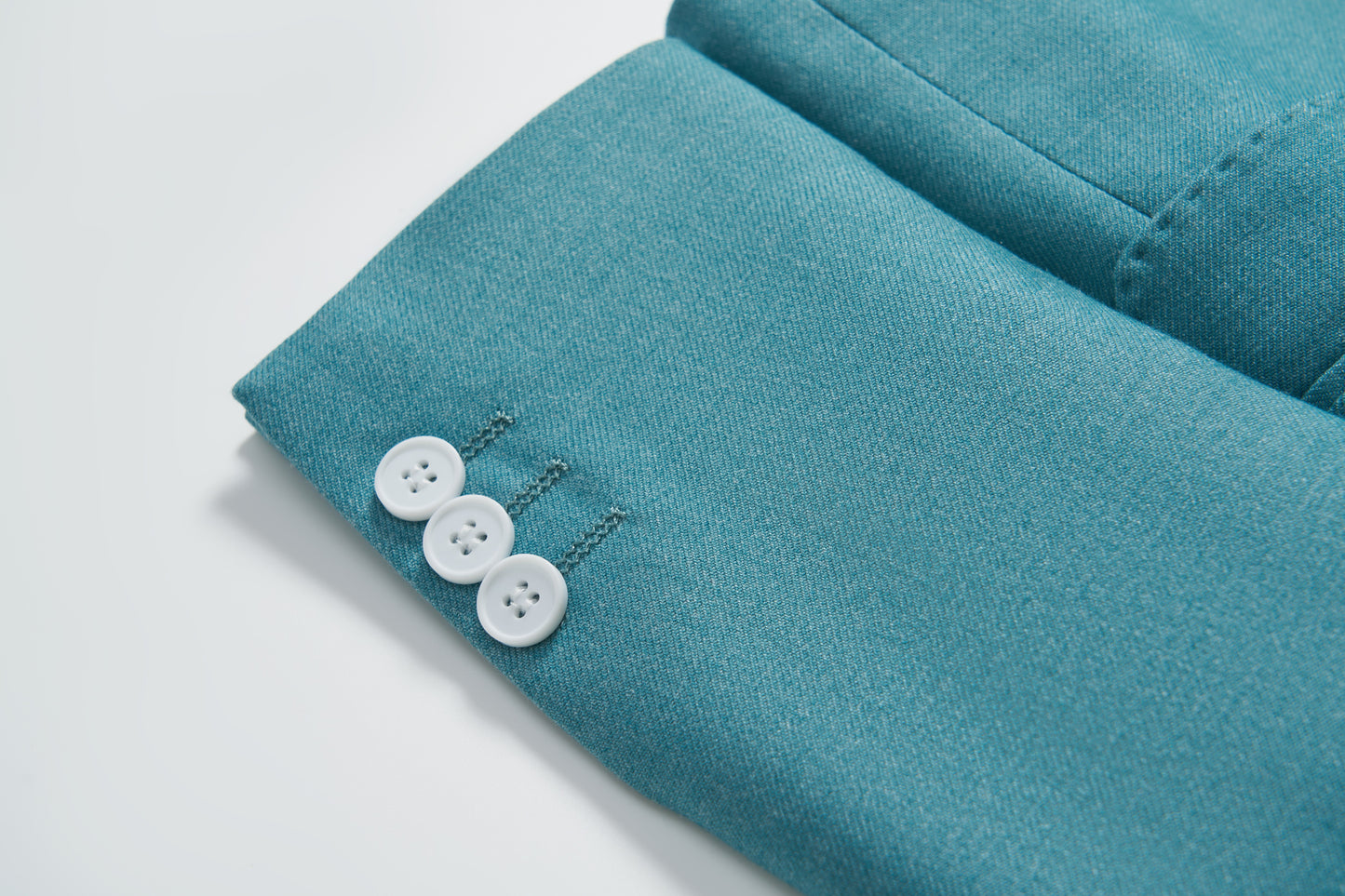 Close-up of the sleeve on the KIKI and JOJO Celeste Whimsy Suit Jacket, showing three white buttons sewn neatly near the cuff.