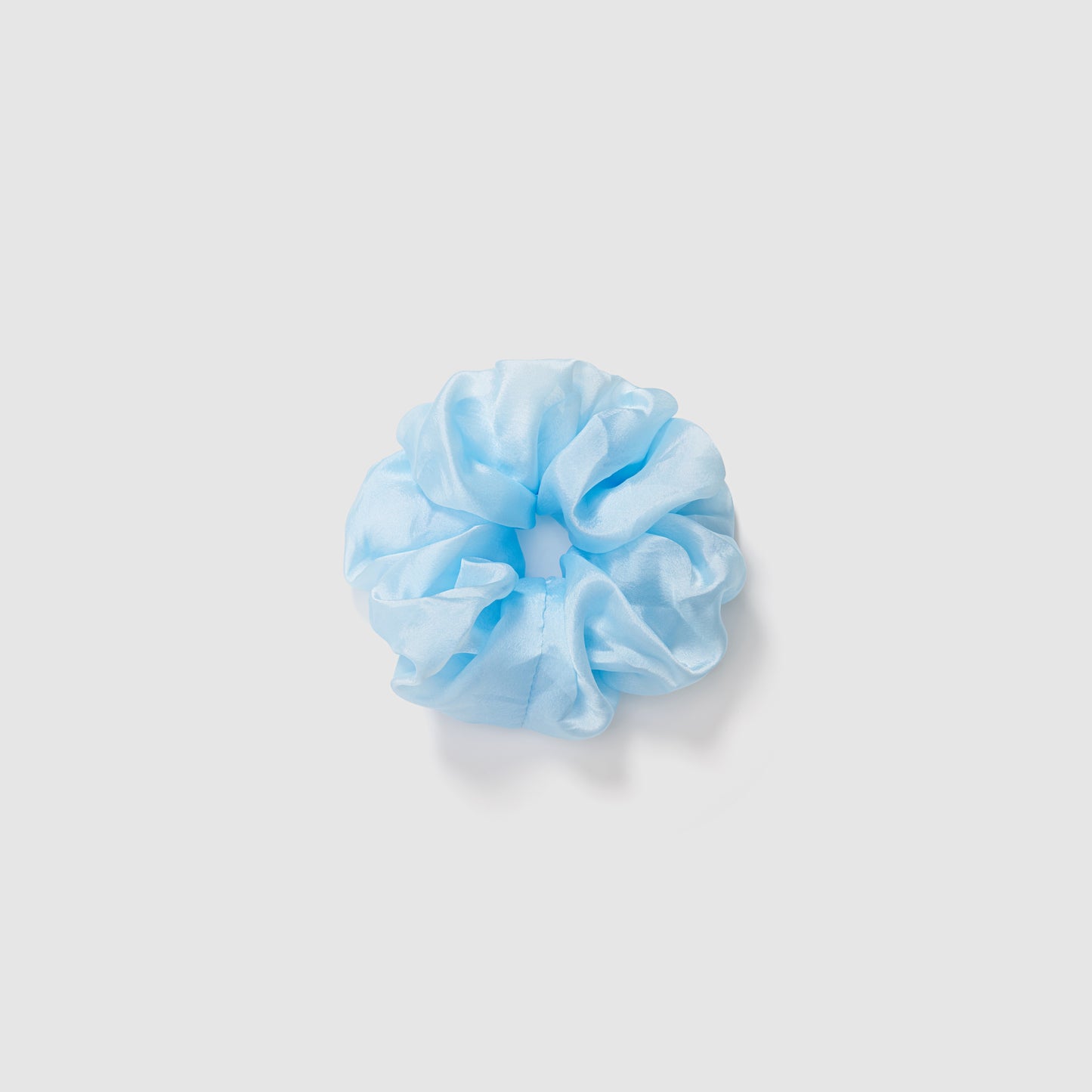 The KIKI and JOJO Girls Cloud Blue Organza Scrunchie is shown against a plain white background, highlighting its delicate style—an ideal hair accessory for any occasion.