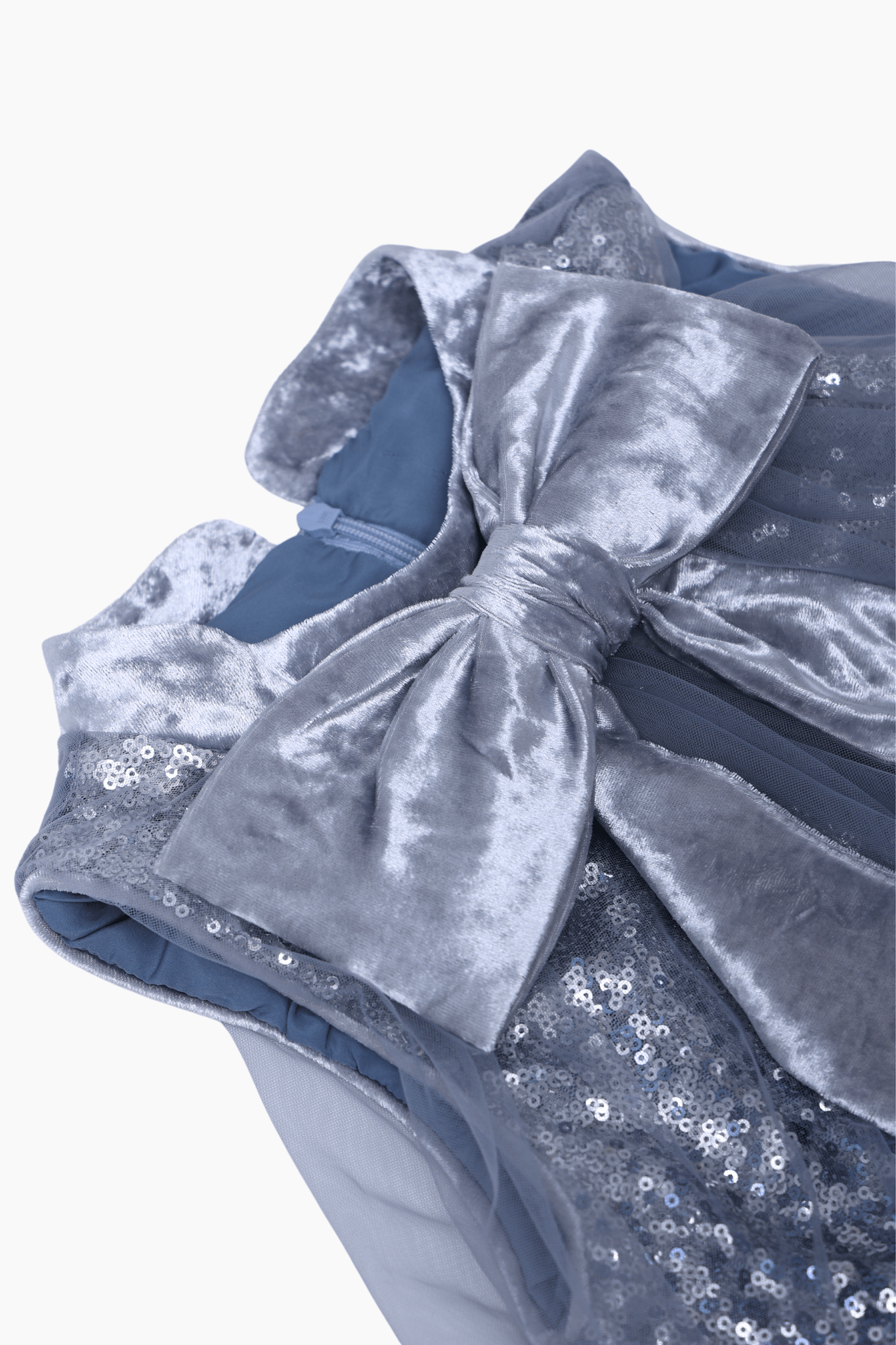 Close-up of the KIKI and JOJO Girls Sequin Tulle Dress in Starlight Blue, showcasing a large, shiny velvet bow and delicate sequin embroidery.