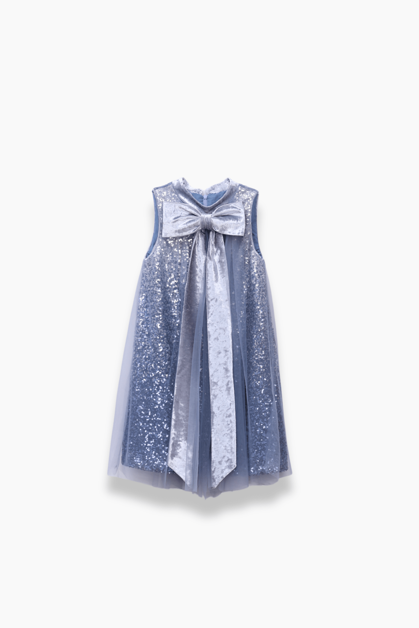 The KIKI and JOJO Girls Sequin Tulle Dress in Starlight Blue features a sleeveless design, sequin embroidery, sheer overlay, and a large metallic bow on the chest, displayed against a white background.