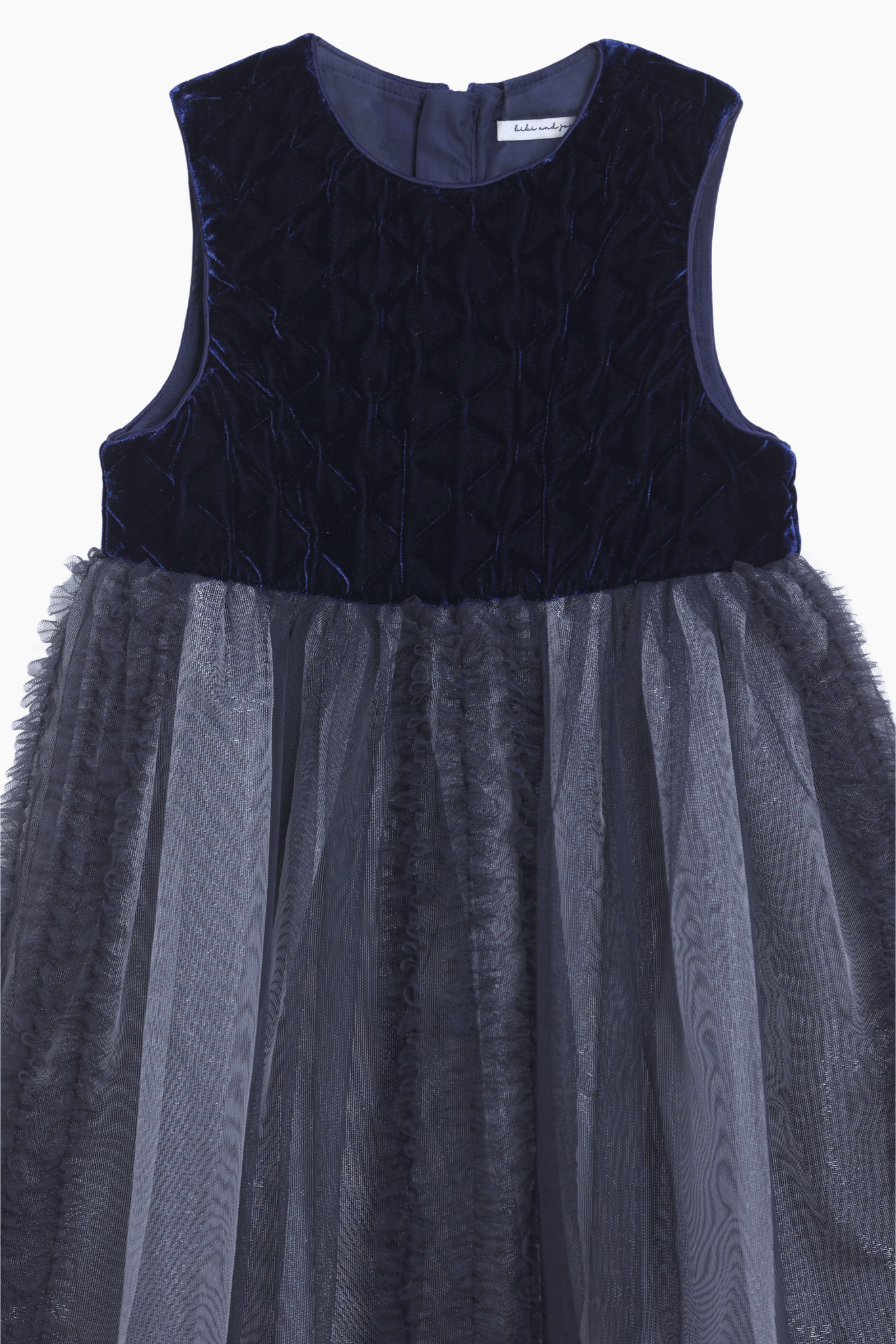 The KIKI and JOJO Girls Velvet & Tulle Dress in Sapphire Blue features a sleeveless, dark blue velvet bodice and layered matching tulle skirt—perfect for special occasions, shown on a white background.