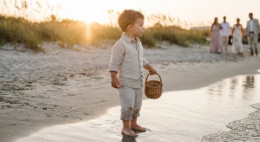 Child in light formal attire at a beach wedding