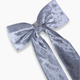 Large silver-gray velvet bow with long tails, secured by a metallic clip, perfect for pairing with the KIKI and JOJO Girls Sequin Tulle Dress in Starlight Blue. Displayed on a white background.