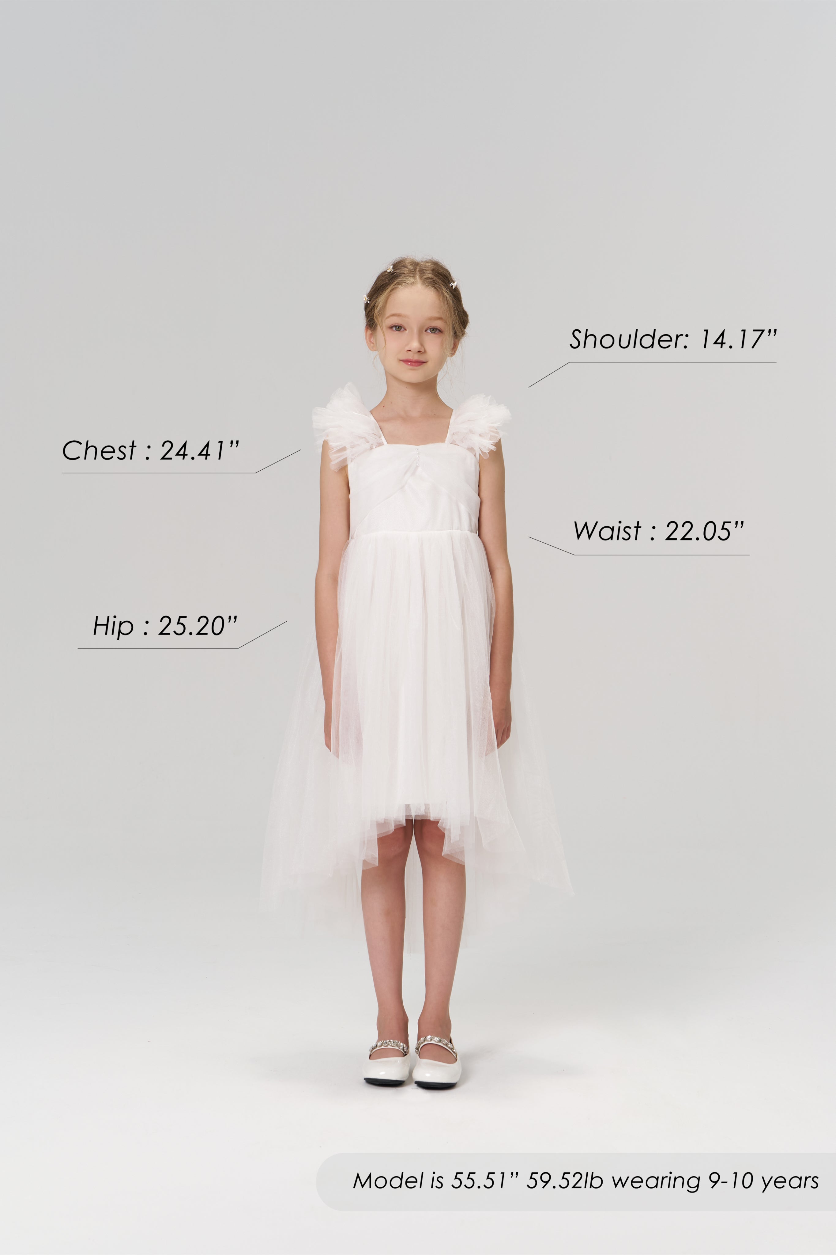 A young girl faces forward in the KIKI and JOJO Cloud Whisper Dress with shoes; her body measurements and model details are labeled around her on a plain light background.