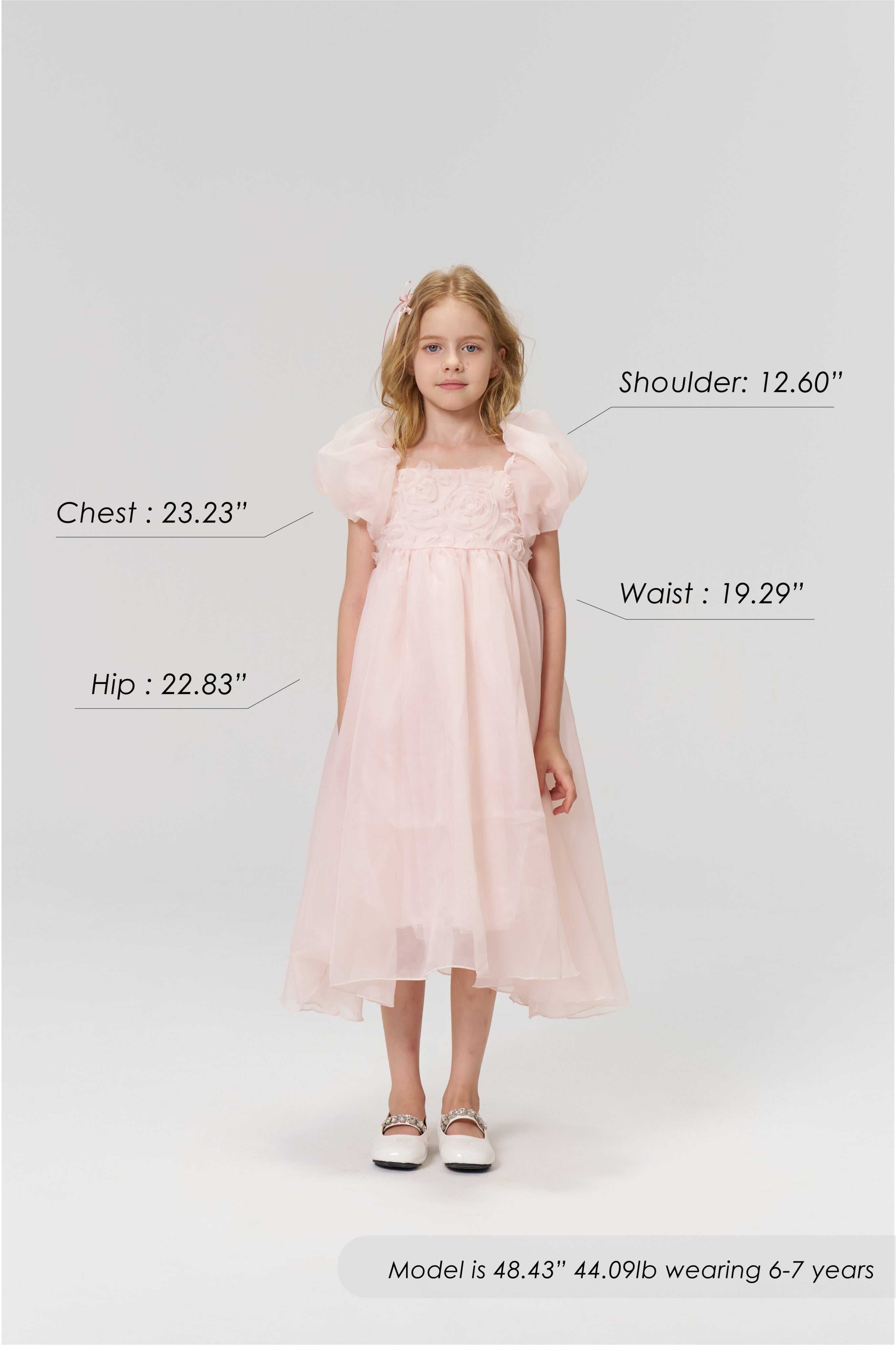 A young girl models the KIKI and JOJO Blush Whisper Dress, featuring puff sleeves in princess style; her chest, hip, shoulder, and waist measurements are shown, along with height, weight, and suitable age range.
