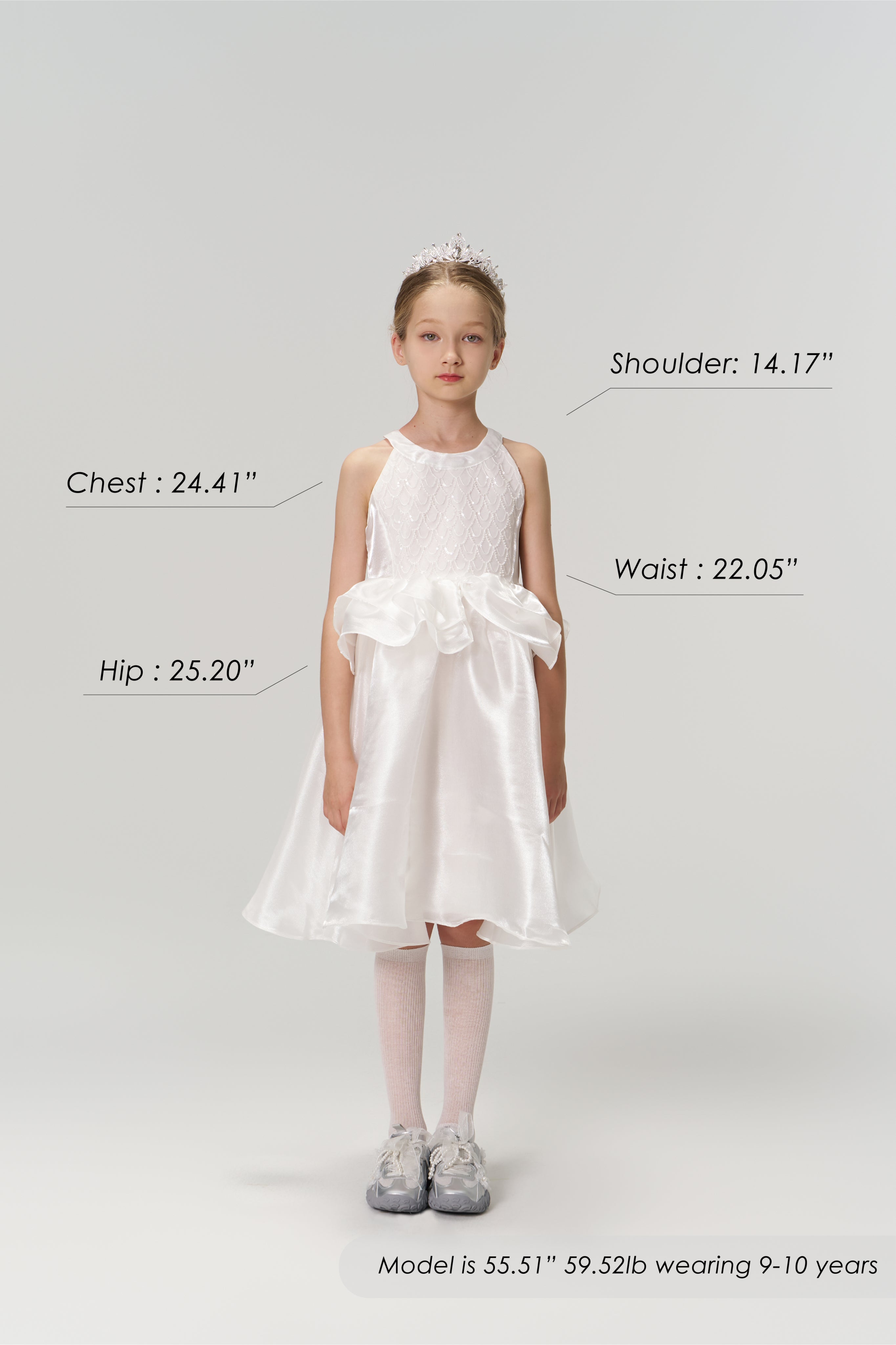 Young girl in the KIKI and JOJO Pearl Glow Whisper Dress with beaded embroidery and tiara stands facing forward; image displays labeled body measurements, height, weight, and age details.