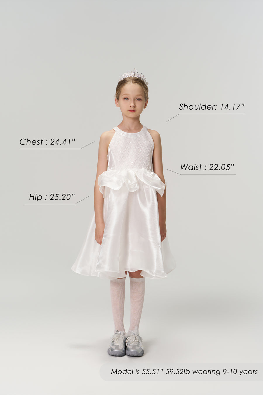 Young girl in the KIKI and JOJO Pearl Glow Whisper Dress with beaded embroidery and tiara stands facing forward; image displays labeled body measurements, height, weight, and age details.