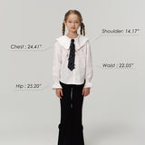 A young girl models KIKI and JOJO's Petal Whisper Dress Pants, featuring a flared silhouette and elastic waistband, paired with a white blouse and sneakers. Measurement labels for chest, shoulder, waist, hip, plus model’s height and weight are shown.