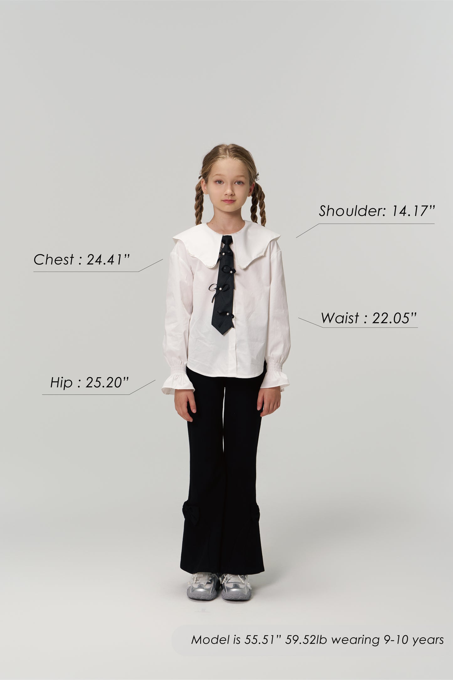 A young girl models KIKI and JOJO's Petal Whisper Dress Pants, featuring a flared silhouette and elastic waistband, paired with a white blouse and sneakers. Measurement labels for chest, shoulder, waist, hip, plus model’s height and weight are shown.