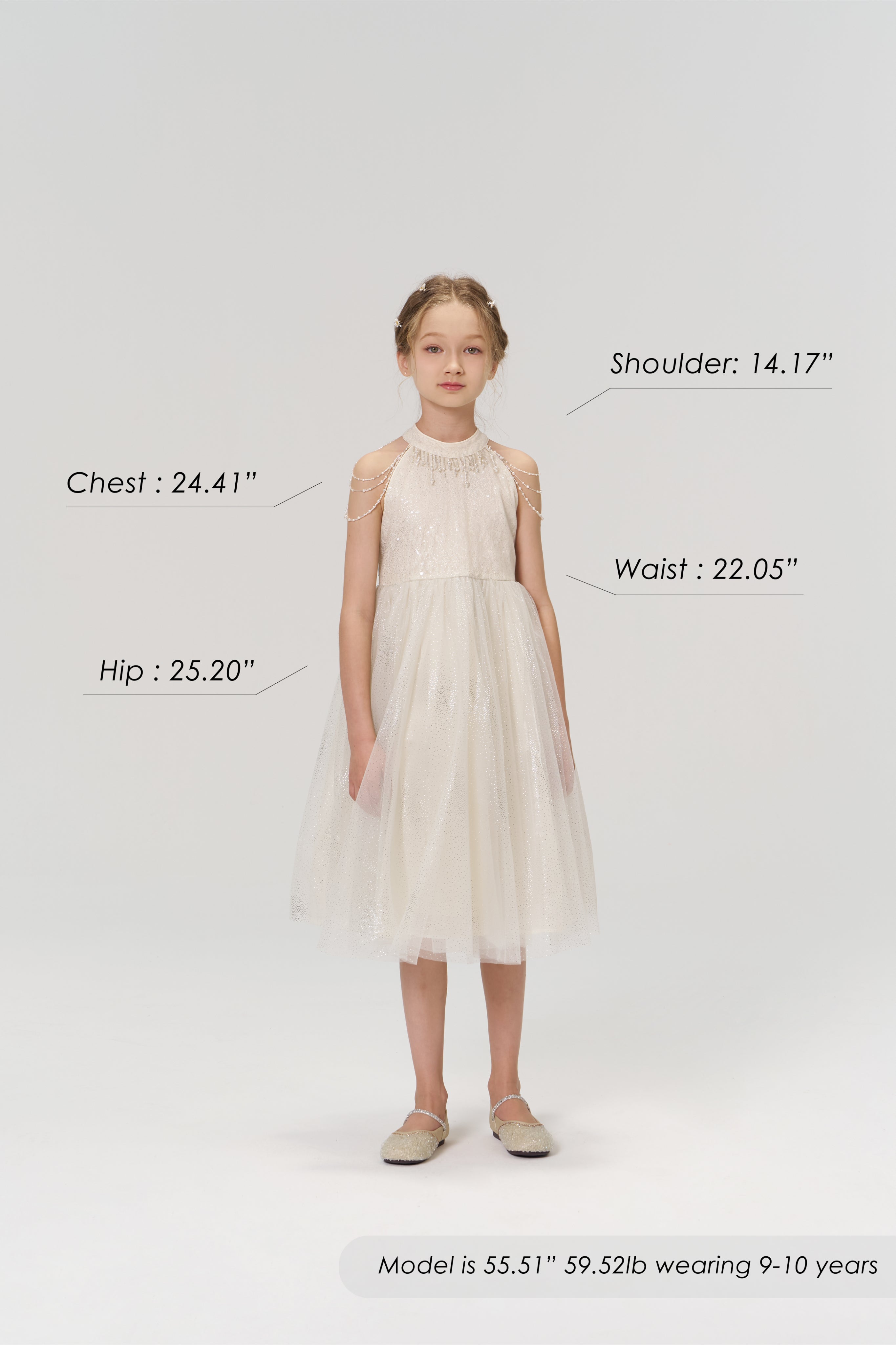 A young girl faces forward in the KIKI and JOJO Gilded Whisper Dress, beige tulle. Model: chest 24.41", waist 22.05", hip 25.20", shoulder 14.17", height 55.51”, weight 59.52 lbs, age 9-10, measurements labeled for fit reference.