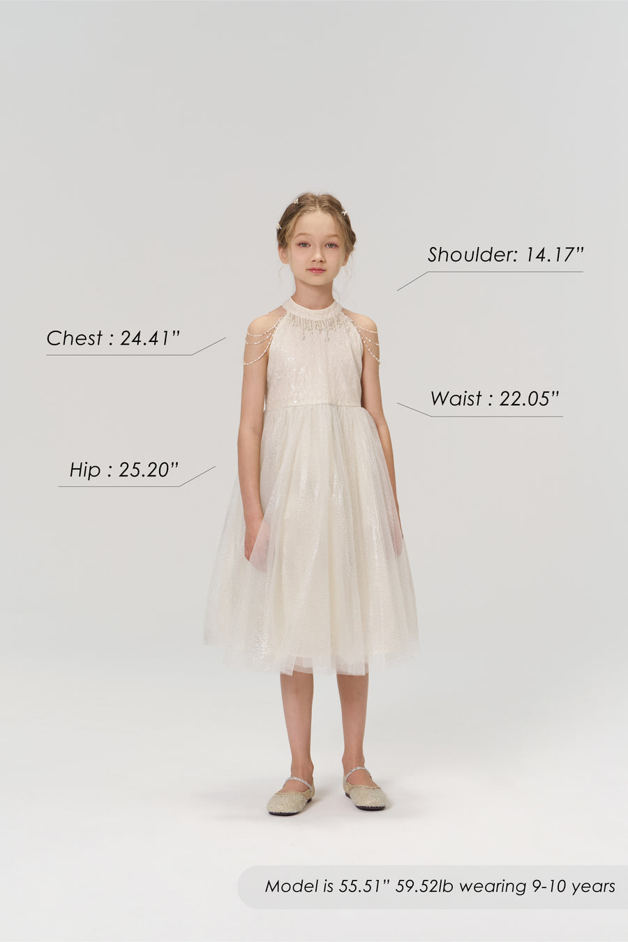 A young girl faces forward in the KIKI and JOJO Gilded Whisper Dress, beige tulle. Model: chest 24.41", waist 22.05", hip 25.20", shoulder 14.17", height 55.51”, weight 59.52 lbs, age 9-10, measurements labeled for fit reference.