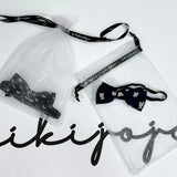 A burgundy satin kids bow tie with bear embroidery from KIKI and JOJO is displayed in a clear drawstring bag above the brand’s name in black script, adding a charming touch.