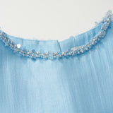 A close-up of the Radiance Satin Crop Top by KIKI and JOJO in light blue, highlighting its hand-beaded pearl neckline with small blue beads and sequins.