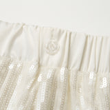 Close-up of an off-white elastic waistband with a transparent button, featured on the KIKI and JOJO Radiance Sequin Wide-Leg Pants with high-rise fit and white sequins.