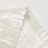 Close-up of Radiance Sequin Wide-Leg Pants by KIKI and JOJO, showcasing shiny sequins stitched in horizontal lines on white fabric against a plain background.