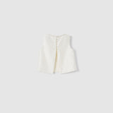 The Radiance Satin Crop Top by KIKI and JOJO is a white sleeveless satin top with a hand-beaded pearl neckline, back slit, and pearl button closures, shown on a plain light grey background.
