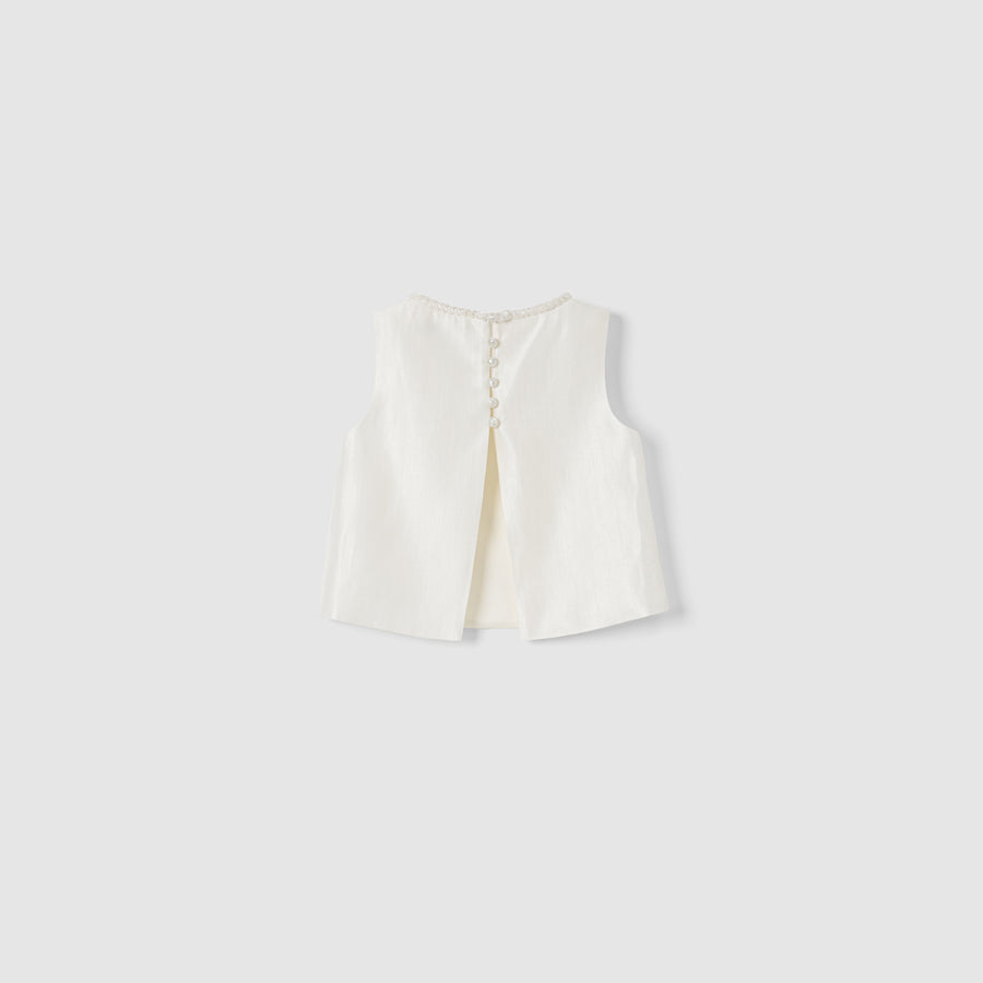 The Radiance Satin Crop Top by KIKI and JOJO is a white sleeveless satin top with a hand-beaded pearl neckline, back slit, and pearl button closures, shown on a plain light grey background.