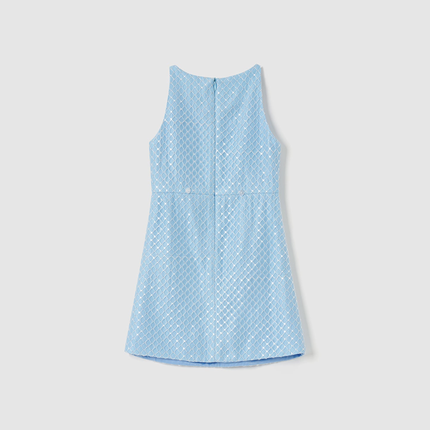 KIKI and JOJO’s Radiance Sequin Overlay Dress in light blue features a sleeveless, diamond-patterned texture. Shown from the back on a plain white background.