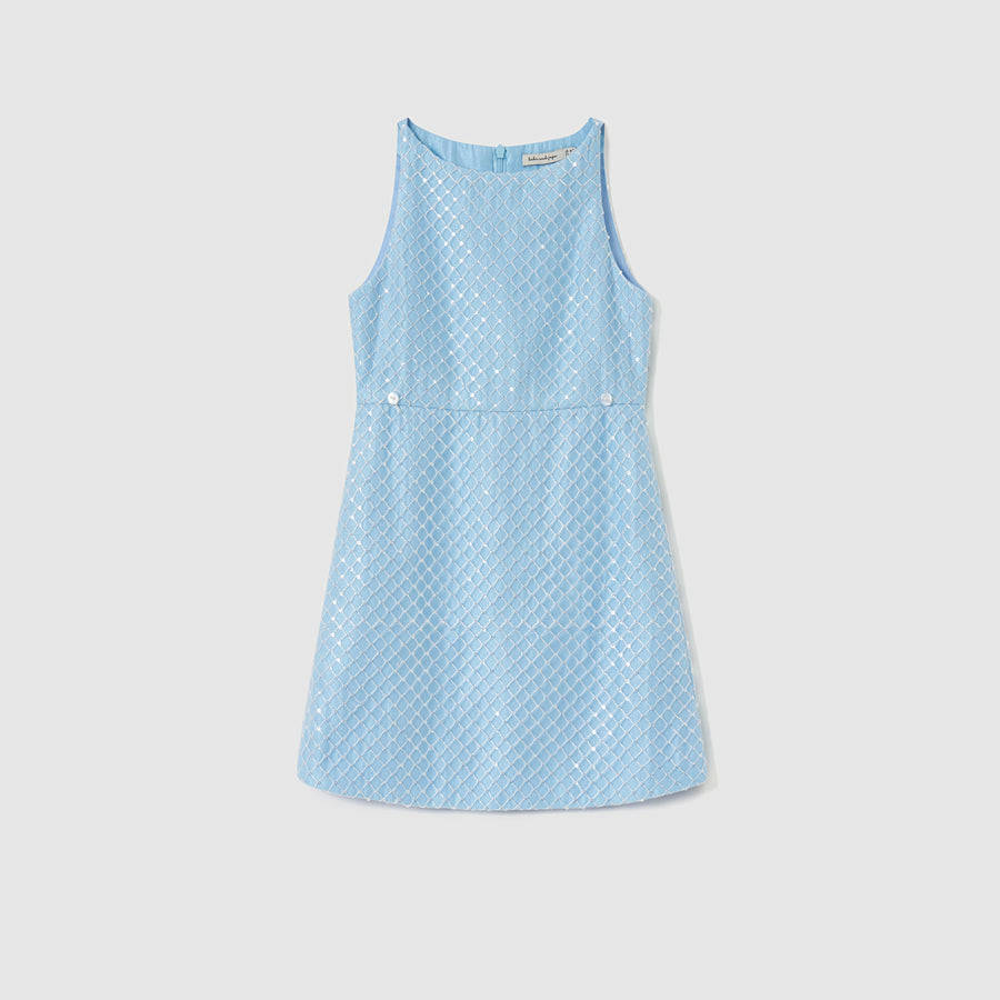 The KIKI and JOJO Radiance Sequin Overlay Dress is a sleeveless light blue formal dress, featuring a diamond-pattern texture, front buttons at the waist, and a back zipper, shown on a plain white background.
