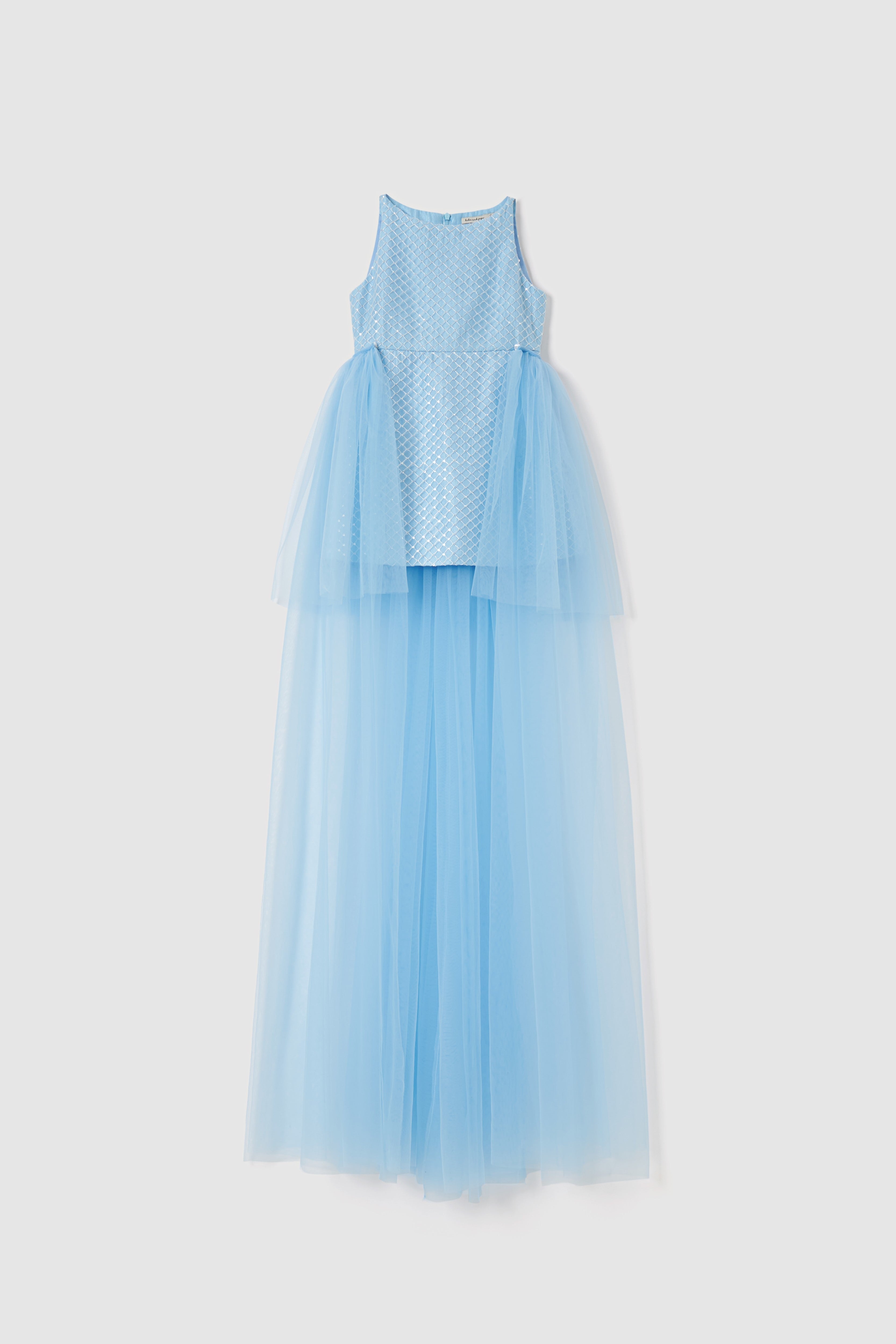 The Radiance Sequin Overlay Dress by KIKI and JOJO features a sleeveless light blue formal design with a fitted polka dot bodice and floor-length layered sequin tulle skirt, displayed against a plain white background.