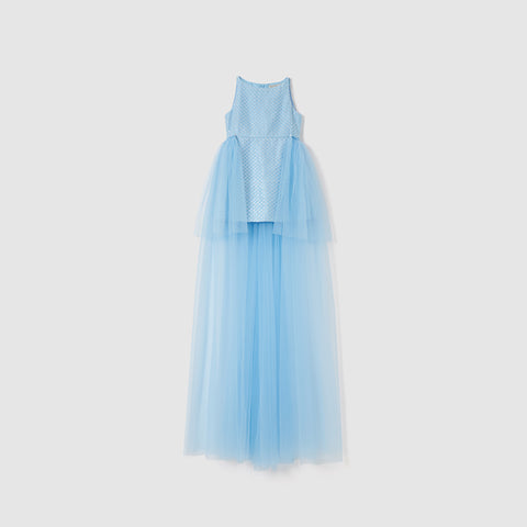 The Radiance Sequin Overlay Dress by KIKI and JOJO features a sleeveless light blue formal design with a fitted polka dot bodice and floor-length layered sequin tulle skirt, displayed against a plain white background.