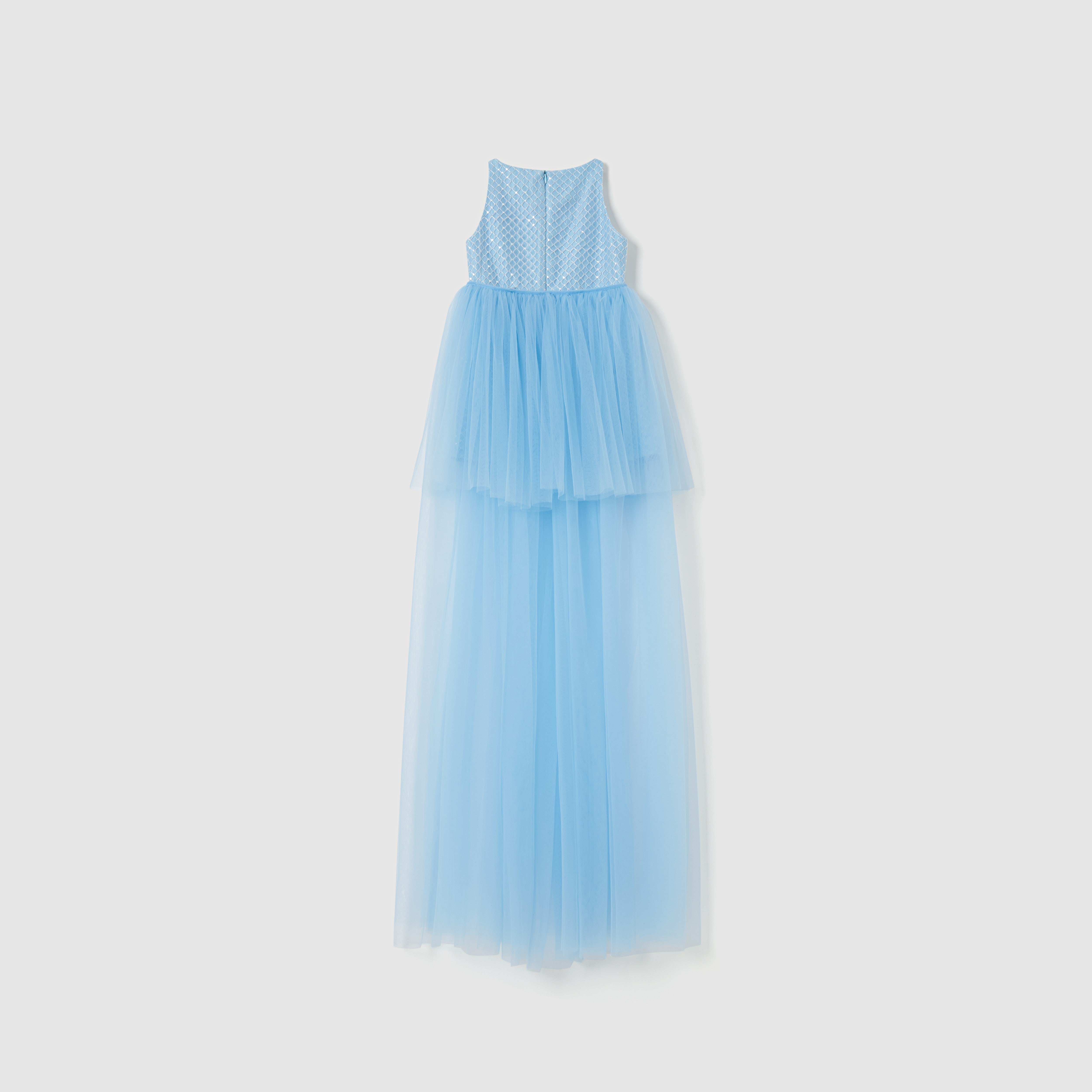 The Radiance Sequin Overlay Dress by KIKI and JOJO is a sleeveless, floor-length blue tulle dress with a fitted bodice and layered skirt, shown against a plain white background.