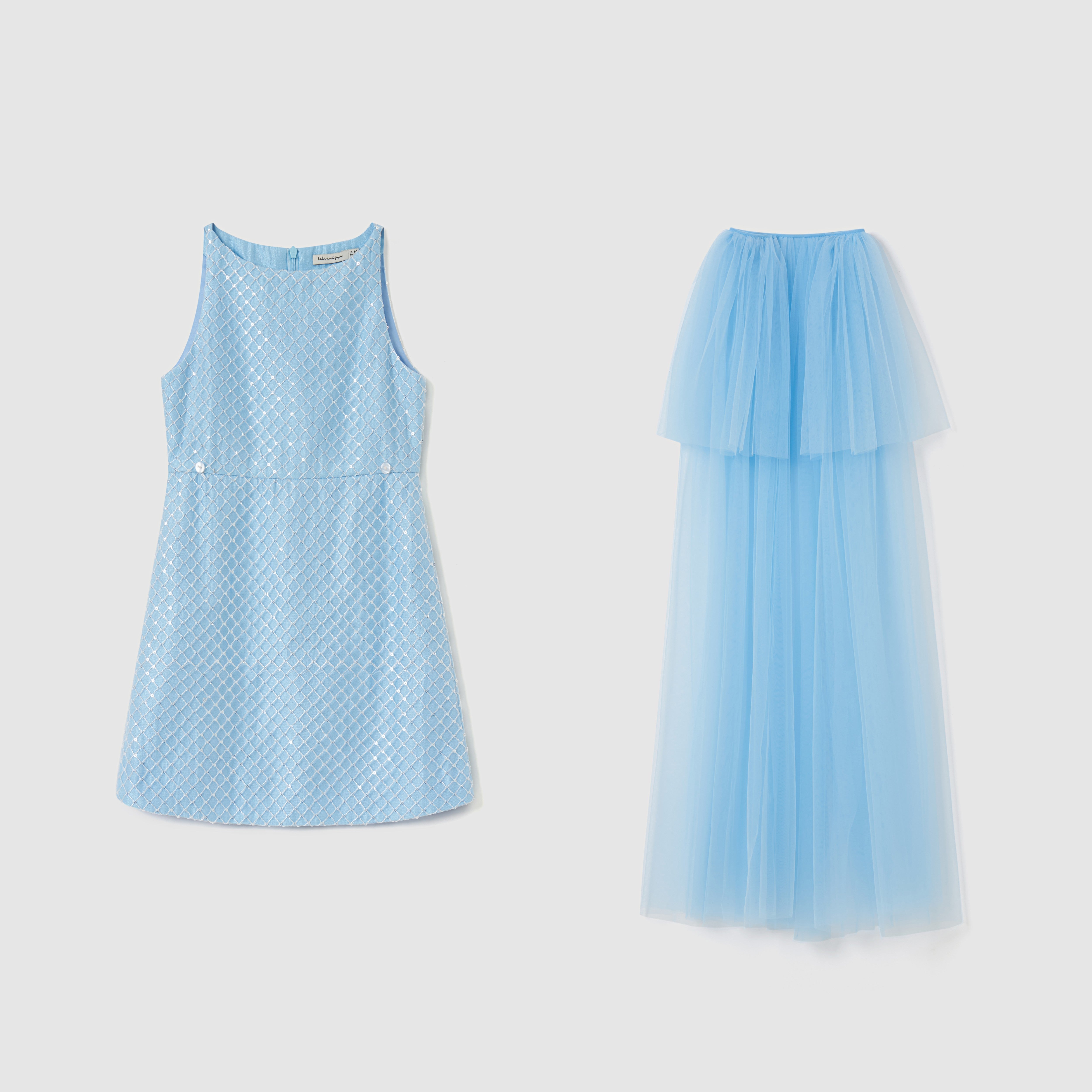 On a plain background: on the left, a sleeveless, patterned light blue A-line dress; on the right, KIKI and JOJO's Radiance Sequin Overlay Dress with layered sequin tulle and a fitted waist.