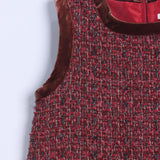 Close-up of the Girls Handmade Tweed Dress – Burgundy Velvet Bow by KIKI and JOJO, showcasing burgundy tweed with velvet trim at the neckline and armhole, back zipper, and detachable velvet bows for a charming finish.