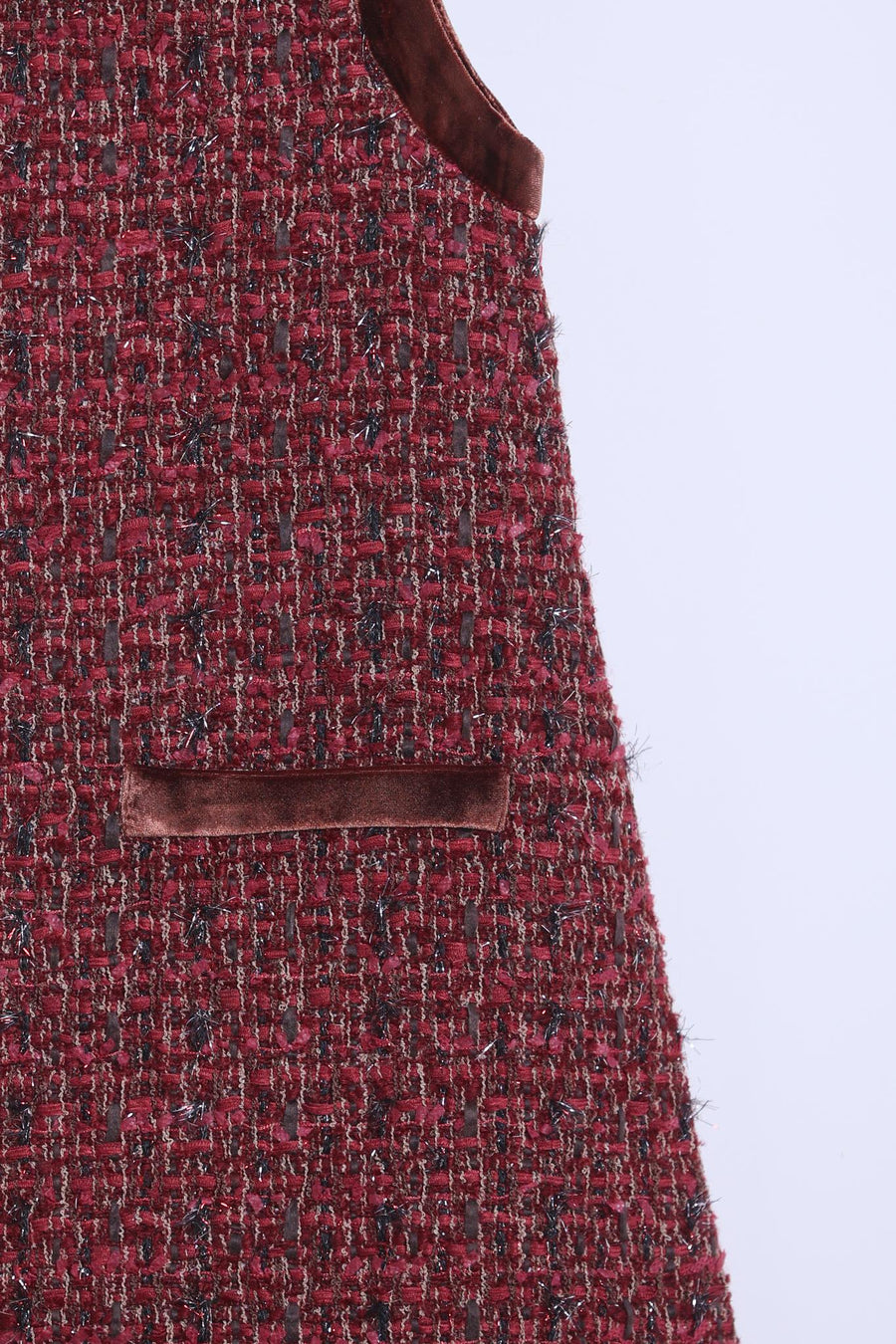 Close-up of KIKI and JOJO's Girls Handmade Tweed Dress – Burgundy Velvet Bow, showcasing its small velvet-trimmed pocket, armhole, and detachable velvet bows against a plain light background.