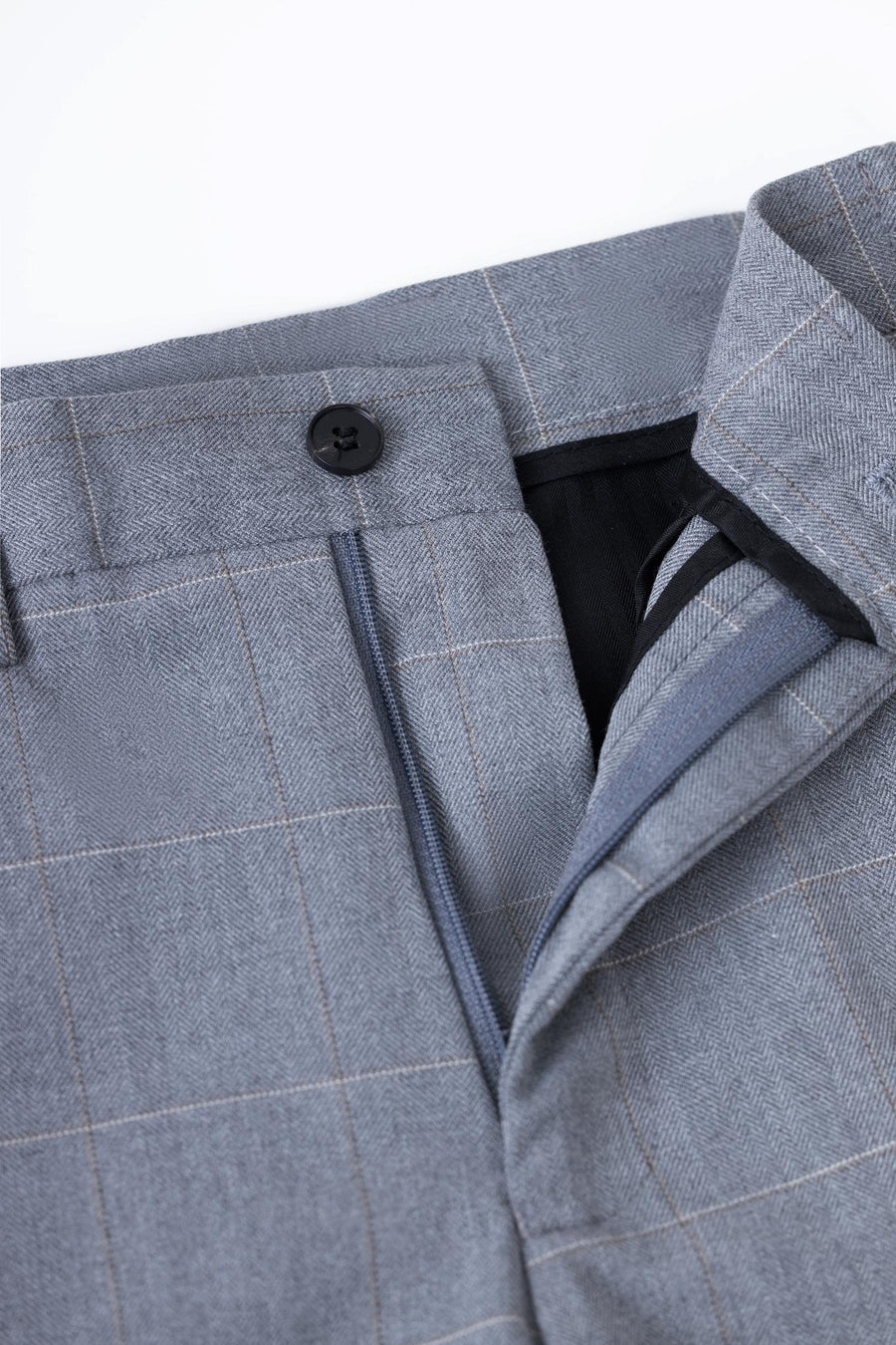 Close-up of the waistband and zipper of KIKI and JOJO Kids Suit Pants in light gray, featuring a checkered pattern, black button closure, and an adjustable waist.