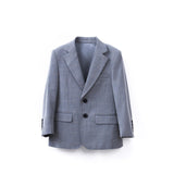 The KIKI and JOJO Kids Suit Jacket in light gray features a checkered pattern, notched lapels, two black buttons, and two front pockets. Wrinkle free, it's shown against a plain white background. Suitable for ages 3-14 years.