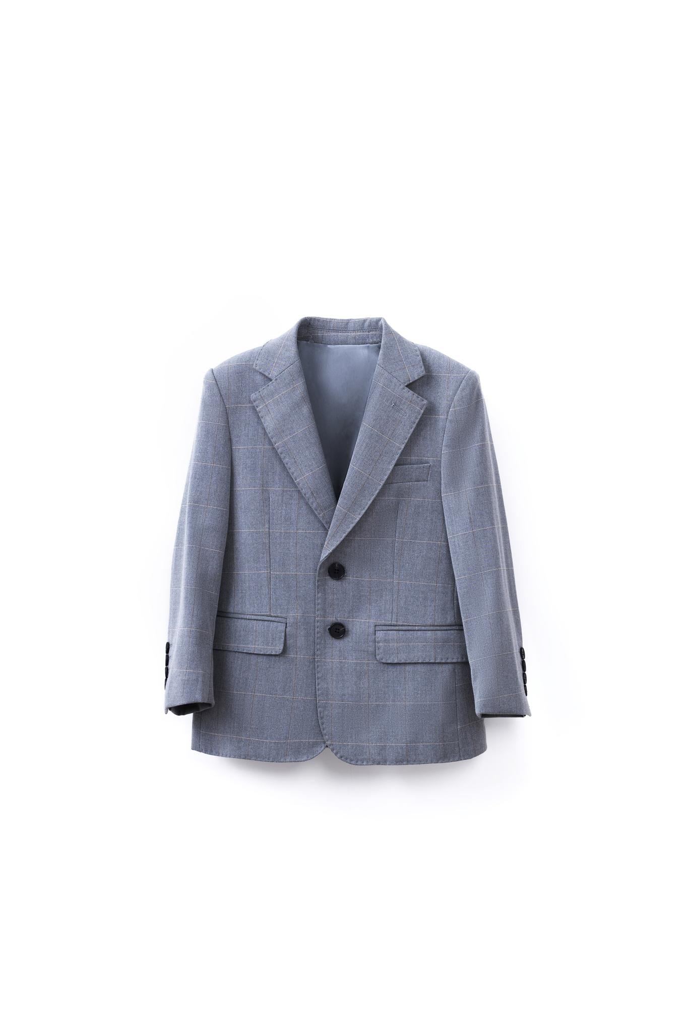 The KIKI and JOJO Kids Suit Jacket in light gray features a checkered pattern, notched lapels, two black buttons, and two front pockets. Wrinkle free, it's shown against a plain white background. Suitable for ages 3-14 years.