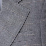Close-up of the KIKI and JOJO Kids Suit Jacket in light gray, checkered, wrinkle-free fabric with notched lapel and chest pocket. Suitable for ages 3-14 years.