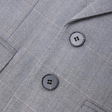 Close-up of the KIKI and JOJO Kids Suit Jacket in light gray checkered, wrinkle-free fabric, with notched lapel and two black buttons. Suitable for ages 3-14 years.
