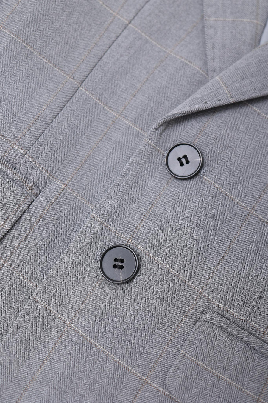 Close-up of the KIKI and JOJO Kids Suit Jacket in light gray checkered, wrinkle-free fabric, with notched lapel and two black buttons. Suitable for ages 3-14 years.