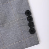 Close-up of the KIKI and JOJO Kids Suit Jacket in Light Gray (3-14 Years), featuring a checkered pattern and four black cuff buttons, crafted from wrinkle-free fabric.
