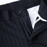 Close-up of KIKI and JOJO Kids Suit Pants in black, classic fit with wrinkle-free fabric, flat-front design, button closure, zipper, and white inner lining. Sizes 3-14 years.
