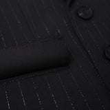Close-up of the KIKI and JOJO Kids Suit Jacket – Black (3-14 Years), classic fit with subtle vertical pinstripes, a pocket, two buttons, and wrinkle-free fabric.