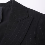 Close-up of the KIKI and JOJO Kids Suit Jacket – Black (3-14 Years), Classic Fit, with subtle white pinstripes, notched lapel, and part of the lining. Made from wrinkle-free fabric for lasting style and comfort.