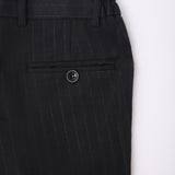 Close-up of KIKI and JOJO Kids Suit Pants – Black (3-14 Years), Classic Fit, wrinkle-free, with pinstripes, flat front, waistband with belt loops, and a single buttoned back pocket.