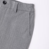 Close-up of KIKI and JOJO Kids Suit Pants – Gray (3-14 Years), classic fit, with belt loops, black button, and side pocket in wrinkle-free fabric.