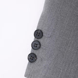 Close-up of the KIKI and JOJO Kids Suit Jacket – Gray, Classic Fit, Wrinkle-Free (3-14 Years) sleeve, featuring a gray herringbone pattern and three black buttons aligned vertically near the cuff.