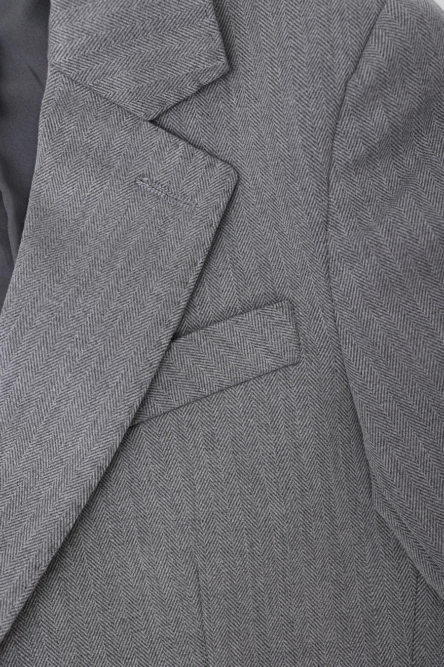 Close-up of the KIKI and JOJO Kids Suit – Gray 3-Piece Set (3-14 Years), classic fit and wrinkle-free, showing herringbone-patterned jacket lapel, collar, and chest pocket.