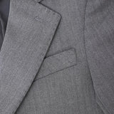 Close-up of the KIKI and JOJO Kids Suit Jacket in gray herringbone, classic fit, wrinkle-free, showing lapel and breast pocket. Suitable for ages 3-14.