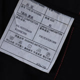 Close-up of a KIKI and JOJO label for Kids Suit Pants – Black (3-14 Years), slim-fit, wrinkle-free; shows size, elastic waistband, lining, fabric makeup, and washing instructions in English and Chinese.