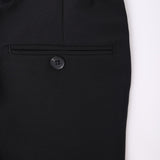 Close-up of KIKI and JOJO Kids Suit Pants – Black (3-14 Years), showing the slim-fit wrinkle-free waistband, a single black button, and belt loop against a white background.