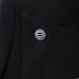 Close-up of the KIKI and JOJO Kids Suit Jacket in black, a slim-fit, wrinkle-free design for ages 3-14, featuring a single black button, subtle embroidery on the lower right side, and a classic Mandarin collar.