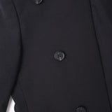 Close-up of the KIKI and JOJO Kids Suit Jacket in black, a wrinkle-free, slim-fit design for ages 3-14, featuring four black buttons and front pocket detail.